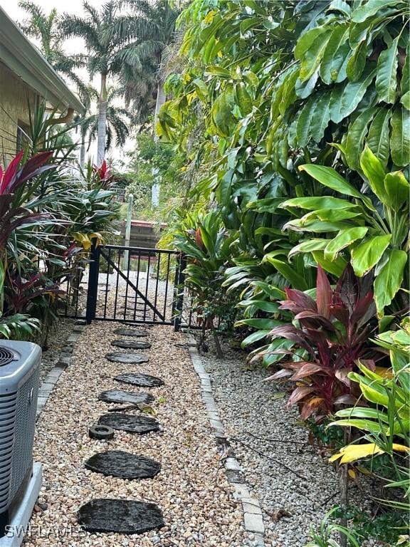 view of yard featuring cooling unit and a gate