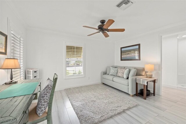 living area featuring a ceiling fan, visible vents, wood finished floors, and ornamental molding