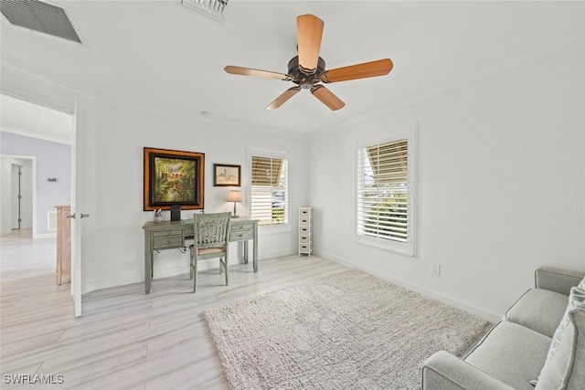 home office featuring baseboards, visible vents, and crown molding