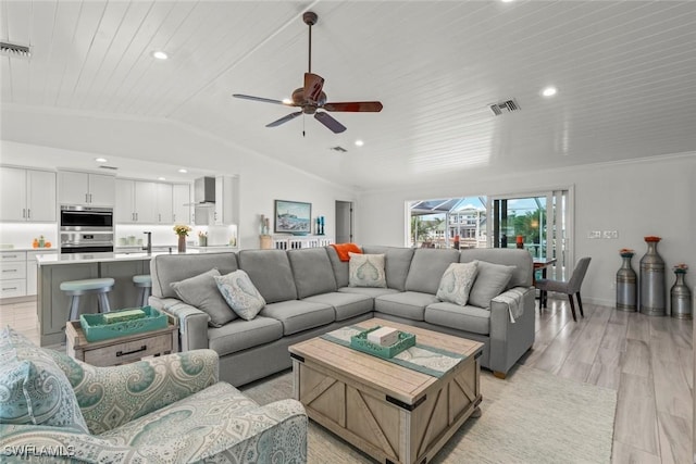 living area featuring light wood finished floors, visible vents, lofted ceiling, wooden ceiling, and crown molding