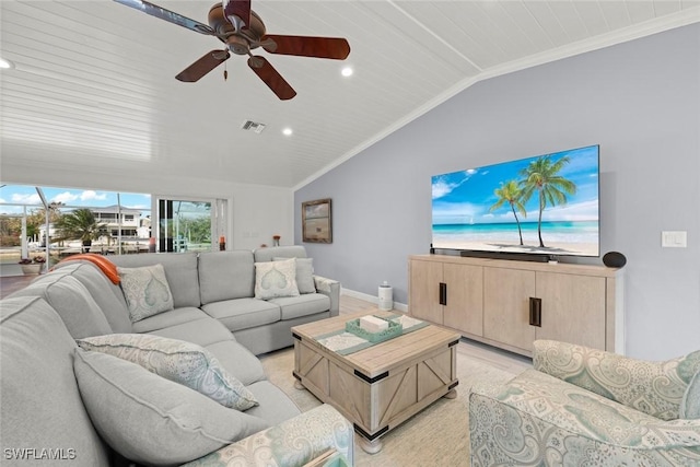 living room with ceiling fan, visible vents, baseboards, vaulted ceiling, and ornamental molding