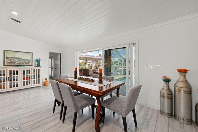 dining room with wooden ceiling, light wood-style flooring, visible vents, baseboards, and crown molding