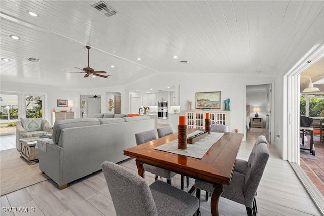 dining space with wooden ceiling, visible vents, and vaulted ceiling