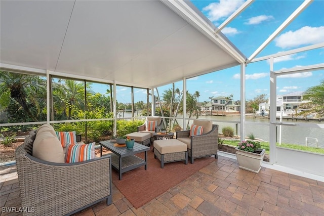 sunroom / solarium with a water view and plenty of natural light