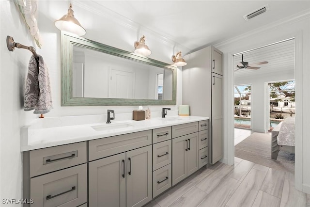 bathroom with visible vents, a sink, ensuite bath, and double vanity