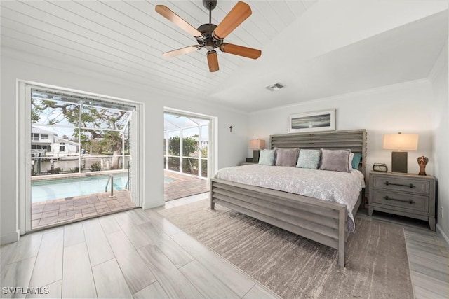 bedroom featuring visible vents, ornamental molding, wood finished floors, access to outside, and vaulted ceiling