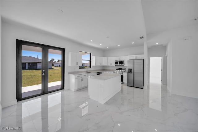 kitchen featuring visible vents, stainless steel appliances, light countertops, french doors, and white cabinetry