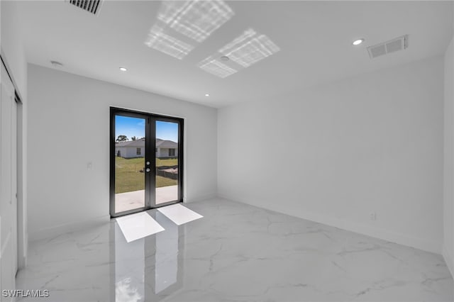 empty room with marble finish floor, french doors, visible vents, and recessed lighting