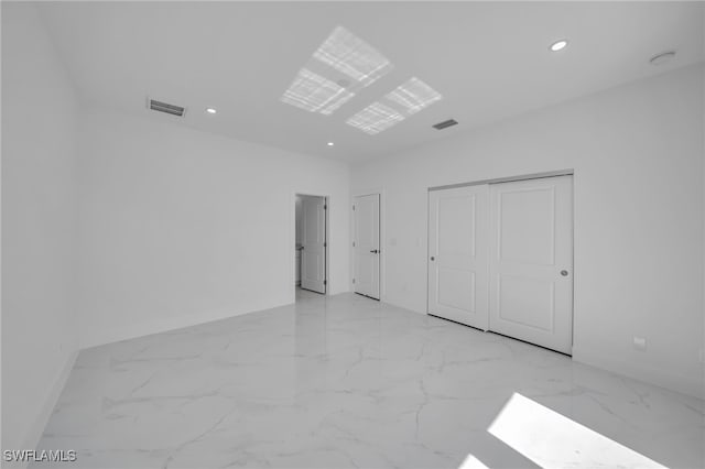 unfurnished room featuring recessed lighting, marble finish floor, and visible vents