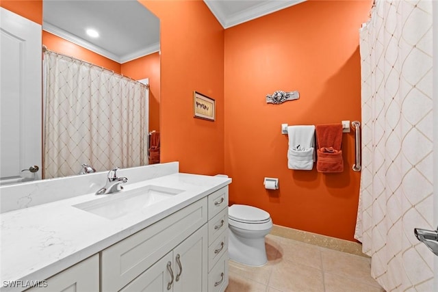 bathroom with toilet, ornamental molding, vanity, tile patterned flooring, and baseboards