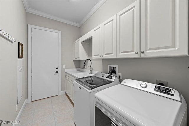 laundry area featuring light tile patterned floors, cabinet space, ornamental molding, a sink, and independent washer and dryer