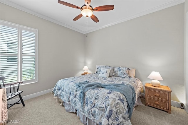 carpeted bedroom featuring baseboards, a ceiling fan, and crown molding