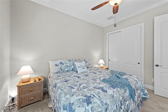 bedroom with carpet floors, ornamental molding, a closet, and baseboards