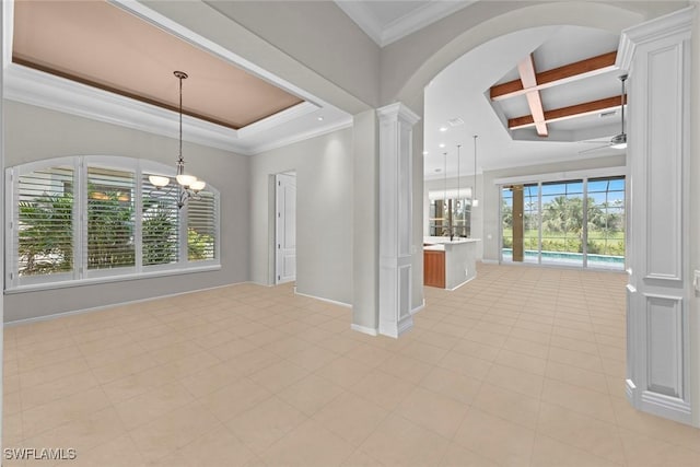 interior space with ceiling fan with notable chandelier, ornamental molding, a wealth of natural light, and ornate columns