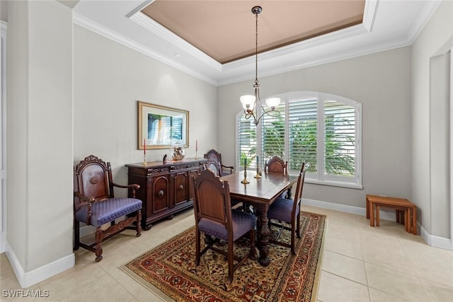 dining area featuring a tray ceiling, light tile patterned floors, ornamental molding, a chandelier, and baseboards