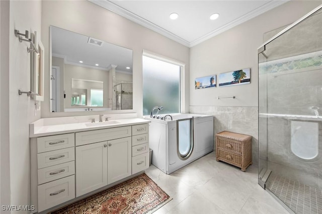 full bathroom with a stall shower, visible vents, crown molding, vanity, and tile walls