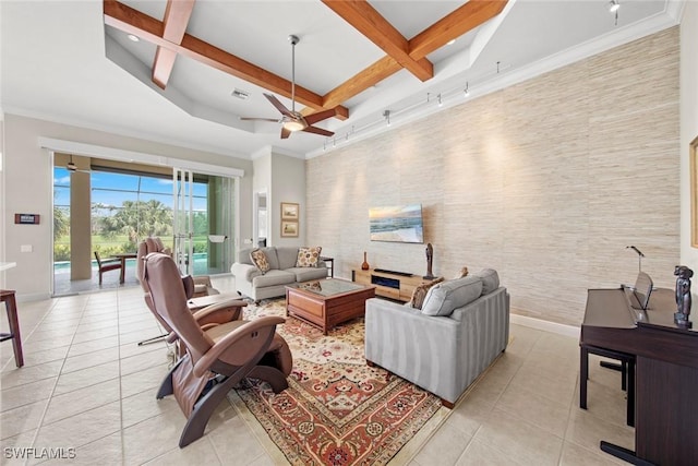 living area featuring baseboards, ornamental molding, beam ceiling, and light tile patterned flooring