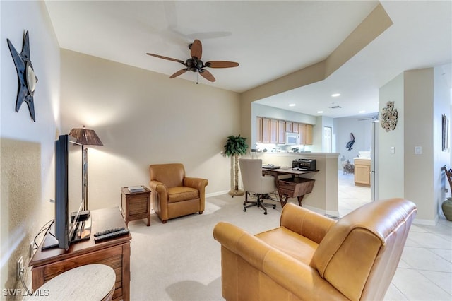 living room featuring light tile patterned floors, a ceiling fan, and baseboards