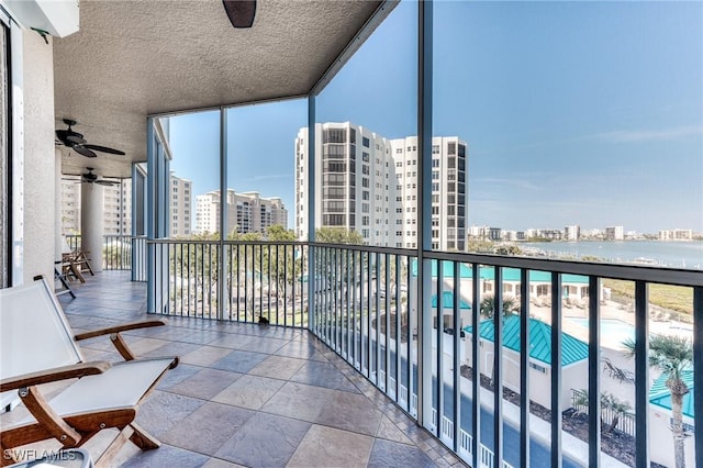 balcony featuring ceiling fan and a city view