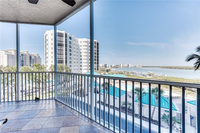 balcony featuring a water view and a city view