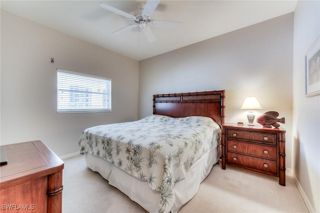 bedroom featuring baseboards, a ceiling fan, and light colored carpet