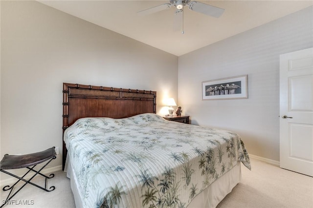 bedroom featuring baseboards, a ceiling fan, and light colored carpet