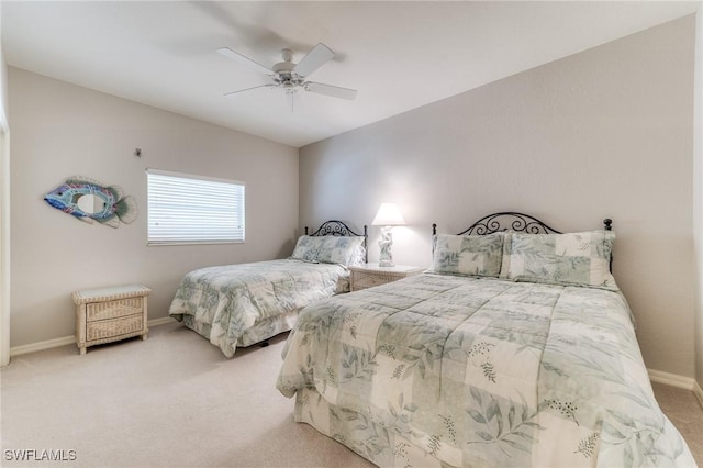 bedroom featuring light carpet, ceiling fan, and baseboards