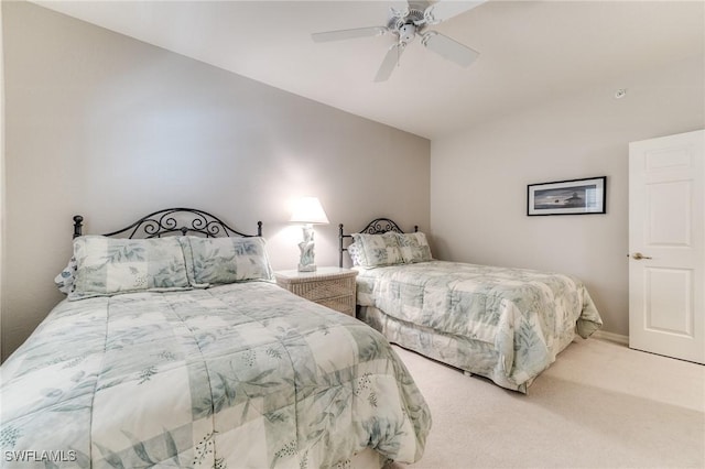 carpeted bedroom with vaulted ceiling and ceiling fan