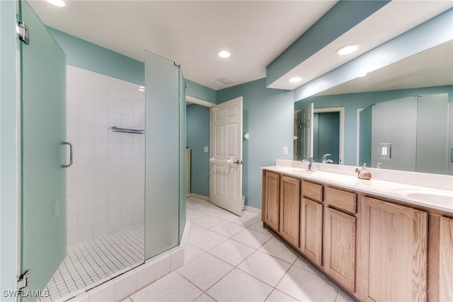 full bath featuring double vanity, recessed lighting, a sink, a shower stall, and tile patterned flooring