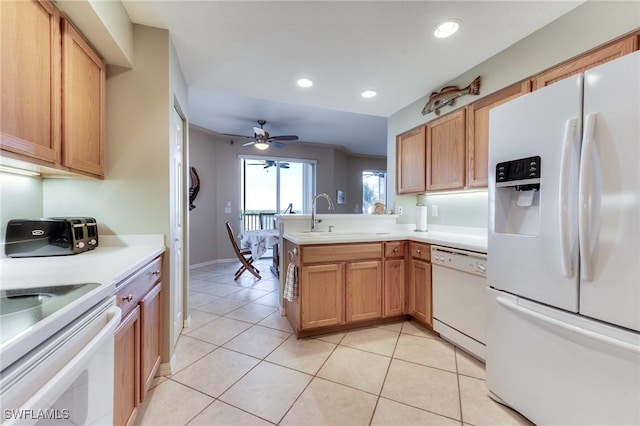 kitchen featuring white appliances, light tile patterned floors, a peninsula, a sink, and recessed lighting