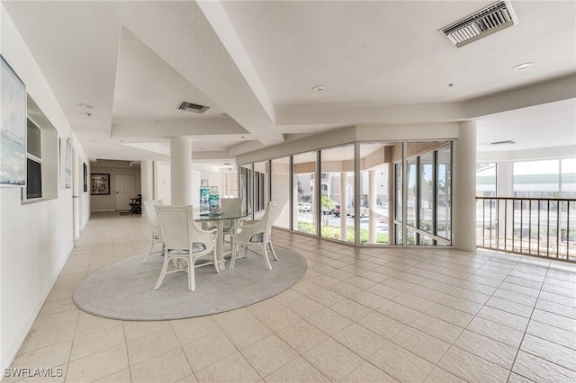 unfurnished dining area featuring light tile patterned floors, baseboards, and visible vents