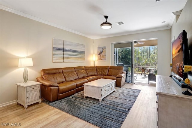 living room with visible vents, ornamental molding, ceiling fan, light wood-type flooring, and baseboards