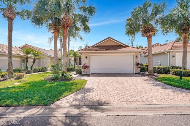 view of front of house with an attached garage, a front yard, decorative driveway, and stucco siding