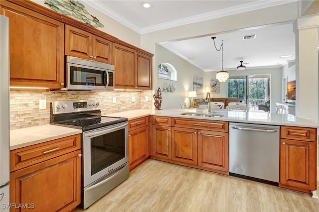 kitchen with visible vents, brown cabinetry, appliances with stainless steel finishes, light wood-type flooring, and a sink