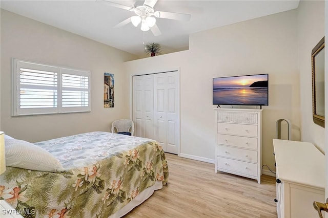 bedroom with light wood-style flooring, baseboards, ceiling fan, and a closet