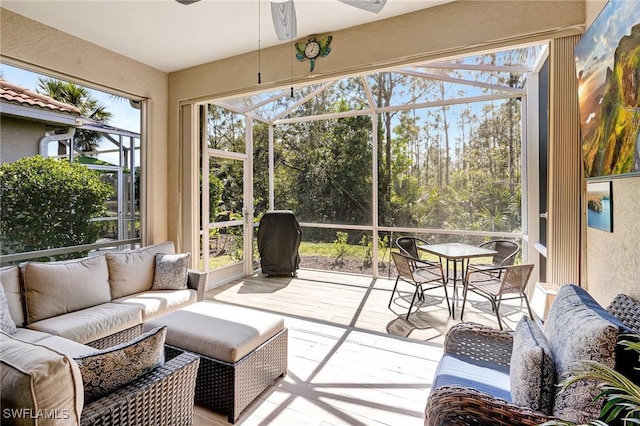 sunroom / solarium featuring a ceiling fan