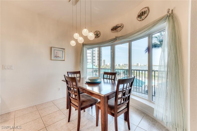 dining area featuring a view of city and light tile patterned floors