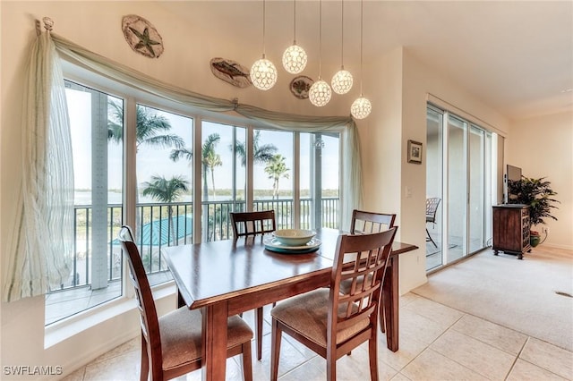 dining area with light tile patterned floors and light colored carpet