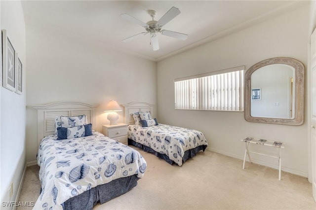 carpeted bedroom featuring ceiling fan and baseboards