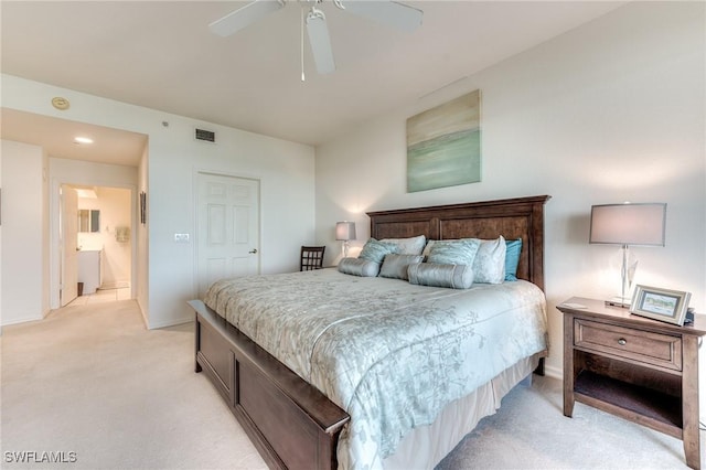 bedroom with light carpet, a ceiling fan, visible vents, and baseboards