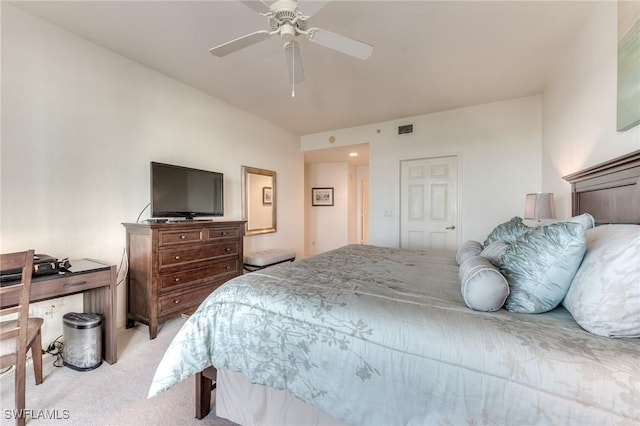 bedroom featuring light carpet, visible vents, and a ceiling fan