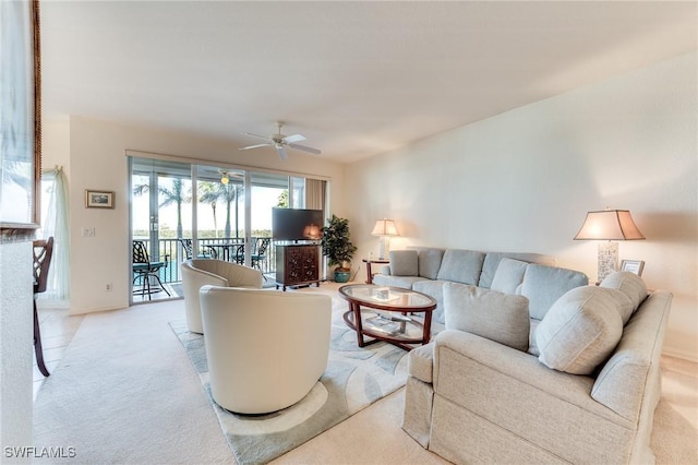 living room with light carpet and a ceiling fan