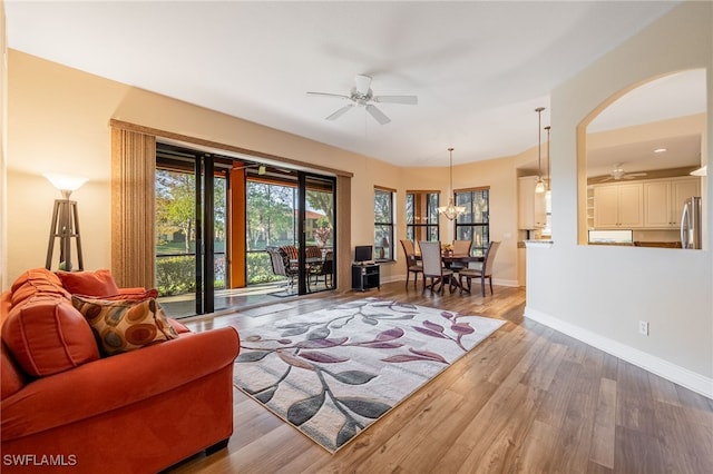 living area with ceiling fan, wood finished floors, and baseboards