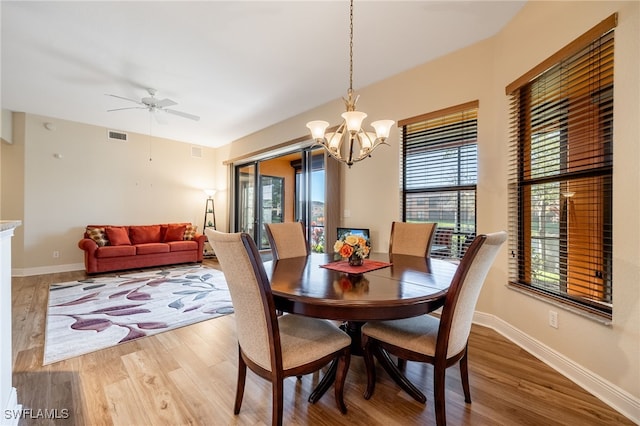 dining area featuring visible vents, baseboards, and wood finished floors