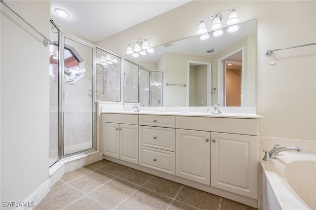 bathroom with double vanity, tile patterned floors, a garden tub, a shower stall, and a sink