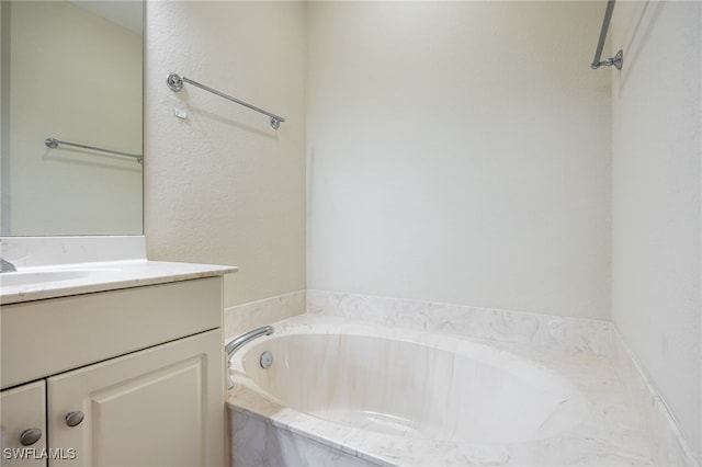 bathroom featuring a garden tub and vanity