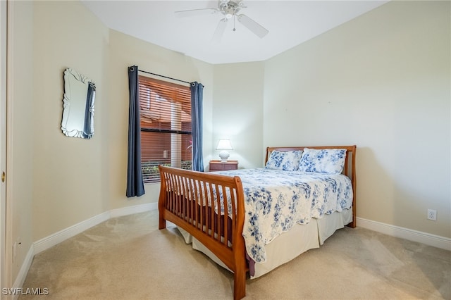 bedroom with light colored carpet, ceiling fan, and baseboards