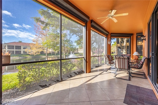 unfurnished sunroom featuring ceiling fan