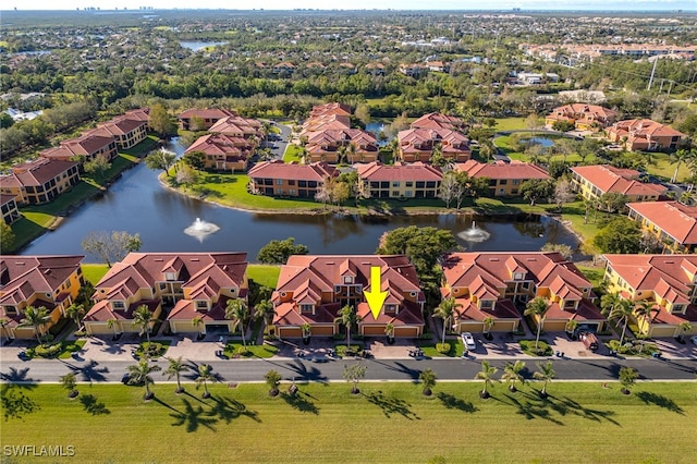 drone / aerial view featuring a water view and a residential view