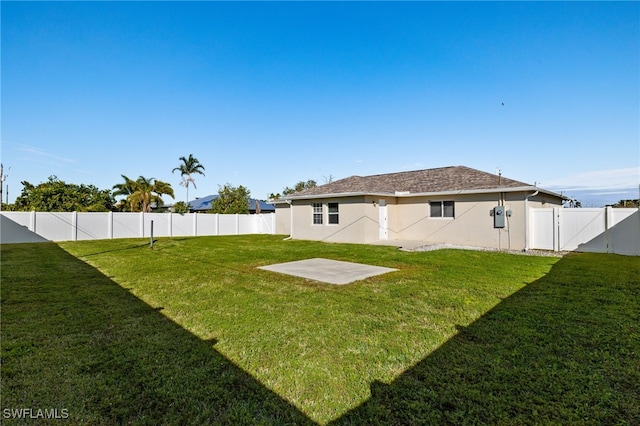 view of yard featuring a fenced backyard and a gate